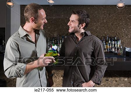 Two men drinking in a bar View Large Photo Image Stock Photography - Two men drinking in a bar. Fotosearch