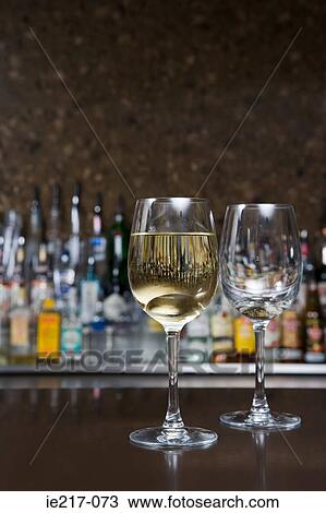 Two wine glasses in a bar View Large Photo Image Stock Image - Two wine glasses in a bar. Fotosearch