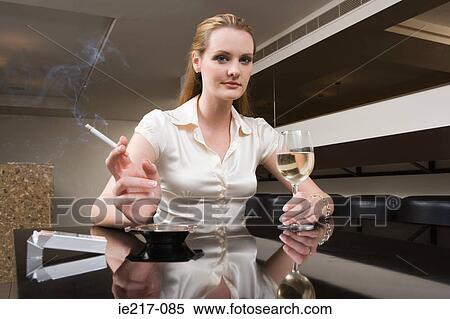Woman smoking and drinking View Large Photo Image Stock Photography - Woman smoking and drinking. Fotosearch