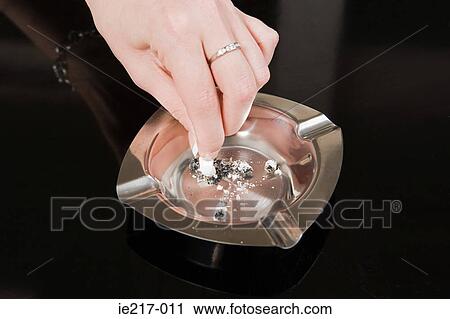Woman stubbing out a cigarette View Large Photo Image Stock Image - Woman stubbing out a cigarette. Fotosearch