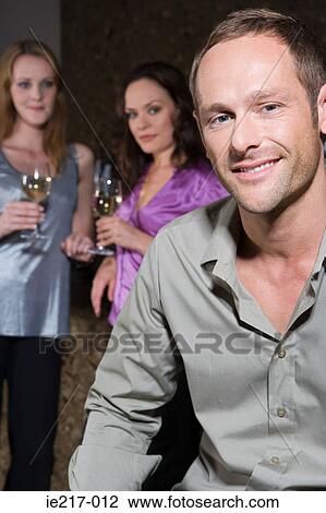 Stock Image - Women looking at an attractive man. Fotosearch
