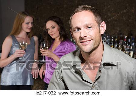 Women looking at an attractive man View Large Photo Image Stock Image - Women looking at an attractive man. Fotosearch