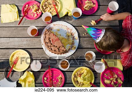 Stock Photography - Boy at the end of a party. Fotosearch