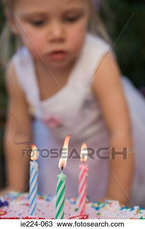 Stock Image - Girl and birthday candles. Fotosearch