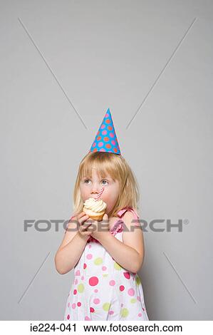 Girl eating a cupcake View Large Photo Image Stock Image - Girl eating a cupcake. Fotosearch