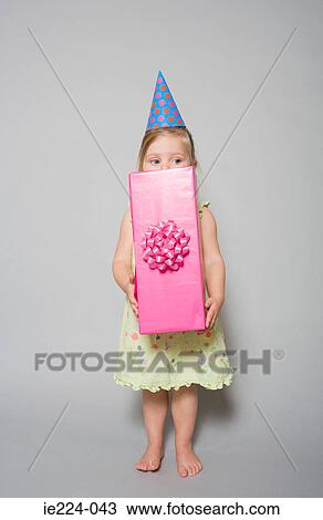 Stock Image - Girl holding a gift. Fotosearch