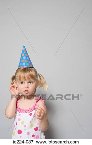 Girl wearing a party hat View Large Photo Image Stock Photo - Girl wearing a party hat. Fotosearch