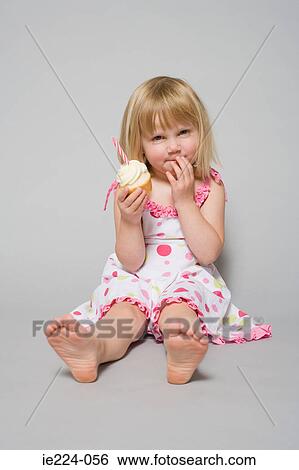 Stock Photograph - Girl with a cupcake. Fotosearch
