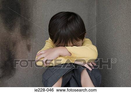 Boy crying in a corner View Large Photo Image Stock Photograph - Boy crying in a corner. Fotosearch