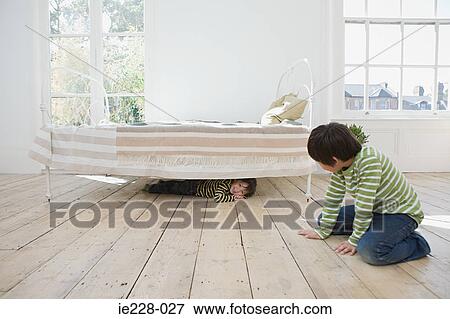 Boys playing hide and seek View Large Photo Image Stock Photo - Boys playing hide and seek. Fotosearch