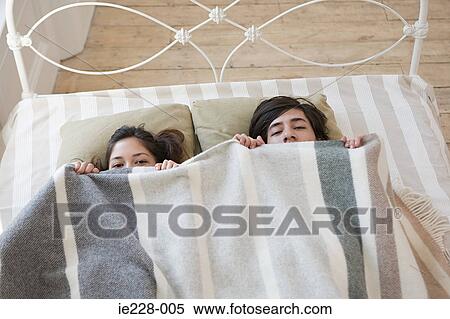 Couple hiding in bed View Large Photo Image Stock Photography - Couple hiding in bed. Fotosearch