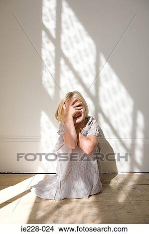 Girl covering her face with her hand View Large Photo Image Picture - Girl covering her face with her hand. Fotosearch