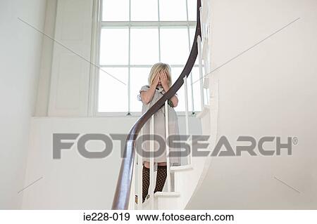 Girl crying on a stairway View Large Photo Image Stock Photo - Girl crying on a stairway. Fotosearch