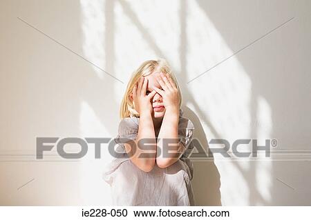 Girl peeking through her fingers View Large Photo Image Stock Image - Girl peeking through her fingers. Fotosearch