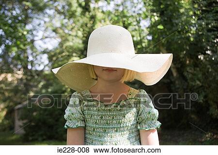 Girl wearing a large sun hat View Large Photo Image Stock Photo - Girl wearing a large sun hat. Fotosearch