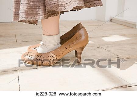 Girl wearing large shoes View Large Photo Image Stock Photo - Girl wearing large shoes. Fotosearch