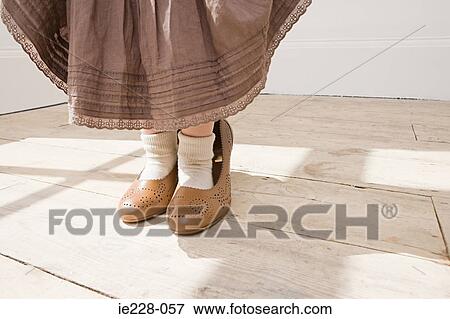 Girl wearing large shoes View Large Photo Image Stock Photo - Girl wearing large shoes. Fotosearch