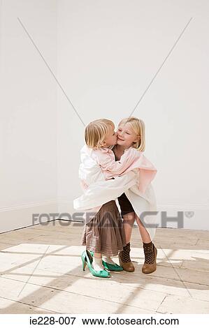 Two young sisters kissing View Large Photo Image Stock Photo - Two young sisters kissing. Fotosearch