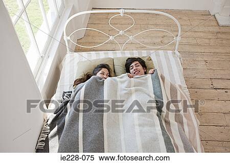 Stock Photography - Young couple in bed. Fotosearch