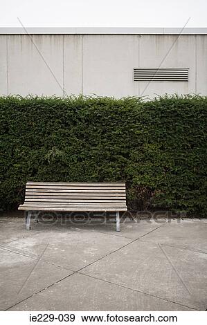 Stock Photo - A bench in a park. Fotosearch