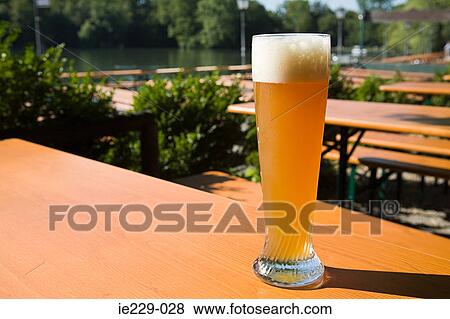 A glass of wheat beer in a german beer garden View Large Photo Image Stock Photo - A glass of wheat beer in a german beer garden. Fotosearch
