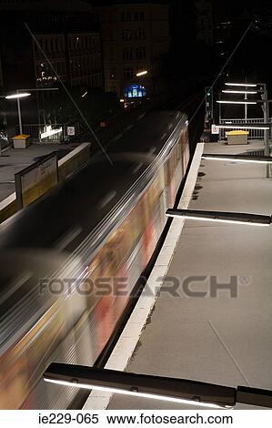 Train going through a railway station View Large Photo Image Stock Photography - Train going through a railway station. Fotosearch
