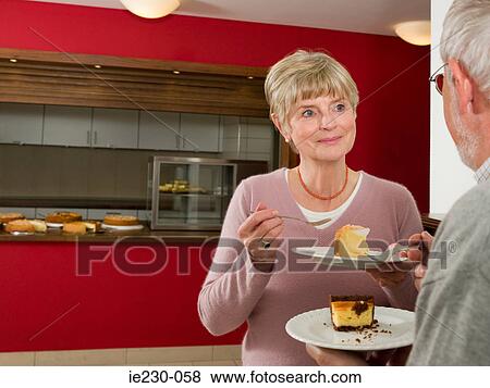 Senior couple eating cake View Large Photo Image Stock Photo - Senior couple eating cake. Fotosearch