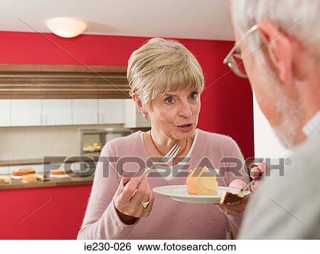 Senior couple eating cake View Large Photo Image Stock Photograph - Senior couple eating cake. Fotosearch