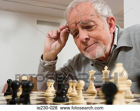 Senior man playing chess View Large Photo Image Stock Photo - Senior man playing chess. Fotosearch