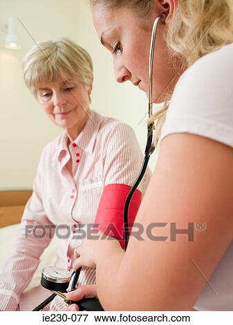 Senior woman having her blood pressure checked View Large Photo Image Stock Photo - Senior woman having her blood pressure checked. Fotosearch