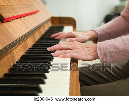 Senior woman playing the piano View Large Photo Image Stock Photograph - Senior woman playing the piano. Fotosearch