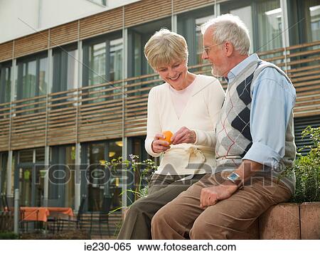 Seniors sitting on a wall View Large Photo Image Stock Photography - Seniors sitting on a wall. Fotosearch