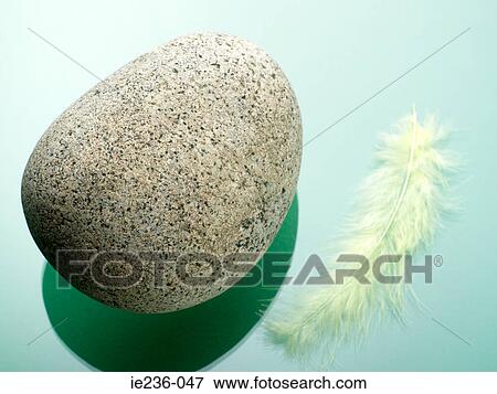 Stone and feather View Large Photo Image Stock Photo - Stone and feather. Fotosearch