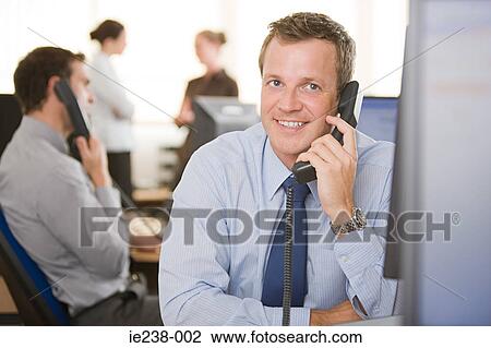 Businessman using a telephone View Large Photo Image Stock Image - Businessman using a telephone. Fotosearch