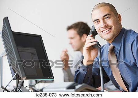 Stock Image - Businessman using a telephone. Fotosearch