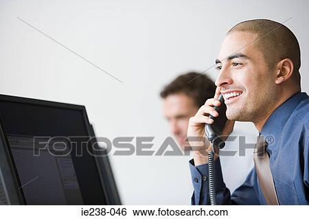 Businessman using a telephone View Large Photo Image Stock Photograph - Businessman using a telephone. Fotosearch
