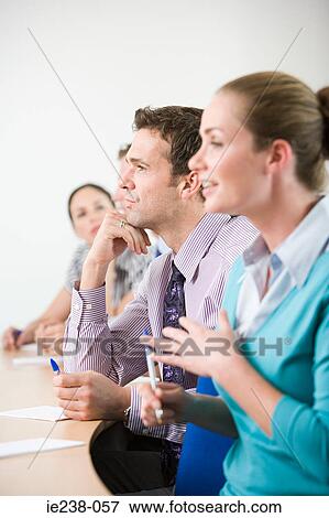 Stock Photo - Businesspeople talking in a meeting. Fotosearch
