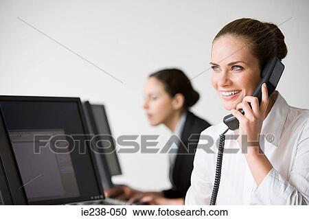 Stock Image - Businesswoman using a telephone. Fotosearch