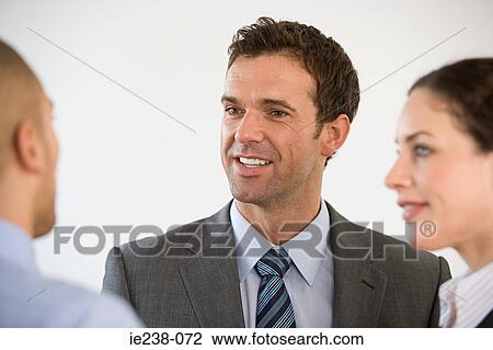 Colleagues talking View Large Photo Image Stock Image - Colleagues talking. Fotosearch