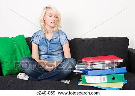 Female student looking at stack of folders View Large Photo Image Stock Photo - Female student looking at stack of folders. Fotosearch