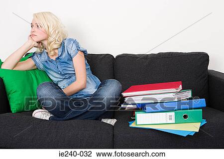 Female student sitting on a sofa View Large Photo Image Stock Image - Female student sitting on a sofa. Fotosearch