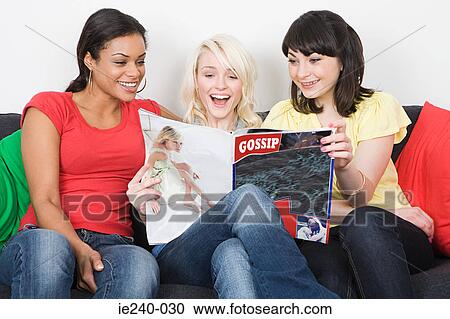 Friends reading a magazine View Large Photo Image Stock Image - Friends reading a magazine. Fotosearch