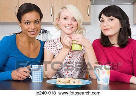 Three female friends in kitchen View Large Photo Image Stock Photo - Three female friends in kitchen. Fotosearch