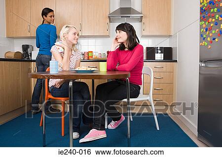 Three flatmates in a kitchen View Large Photo Image Stock Photograph - Three flatmates in a kitchen. Fotosearch