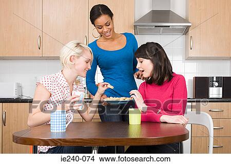 Three women having tea and biscuits View Large Photo Image Picture - Three women having tea and biscuits. Fotosearch