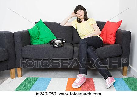 Stock Image - Woman waiting for a telephone call. Fotosearch