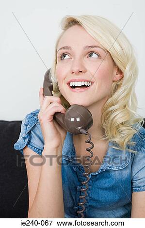 Young woman making a telephone call View Large Photo Image Stock Photo - Young woman making a telephone call. Fotosearch