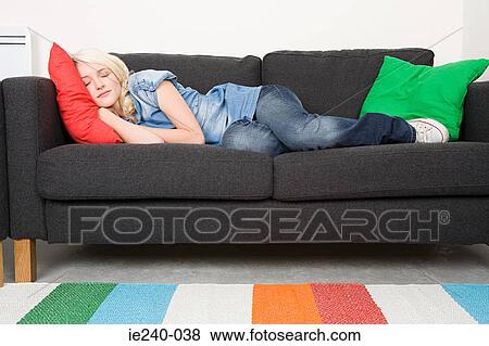 Young woman sleeping on a sofa View Large Photo Image Stock Photo - Young woman sleeping on a sofa. Fotosearch