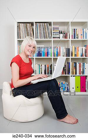 Young woman using a laptop computer View Large Photo Image Picture - Young woman using a laptop computer. Fotosearch