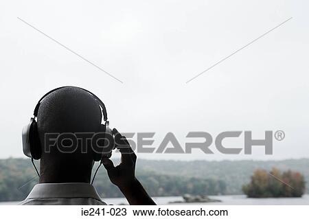 A businessman listening to music View Large Photo Image Stock Image - A businessman listening to music. Fotosearch